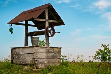Old wooden well in the field