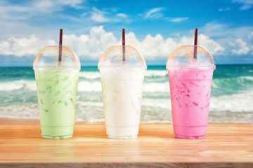 Colorful milk beverages on ocean background