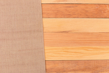 Fabric on wooden table. Soft brown woven linen fabric texture / white wood texture background