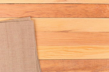 Fabric on wooden table. Soft brown woven linen fabric texture / white wood texture background
