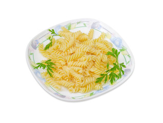 Cooked spiral pasta with parsley twigs on a dish