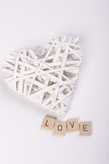 woven white heart with the word "Love"