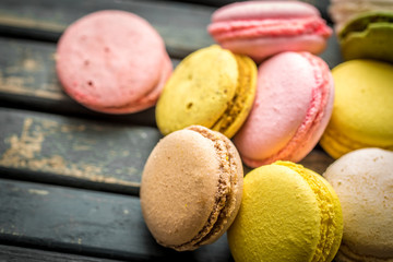Colorful macaroons on wooden background