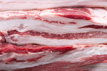 pieces of raw bacon as background, close-up. Selective focus