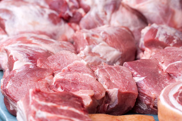 Fresh pieces of pork on the market counter. Selective focus
