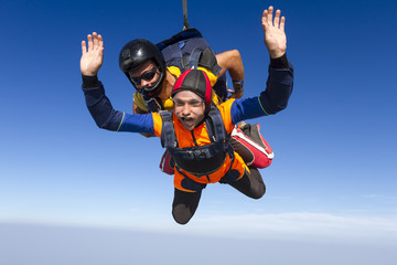 Tandem jump. The instructor and the student in freefall.