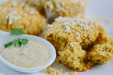 Falafels coated with white sauce, close up