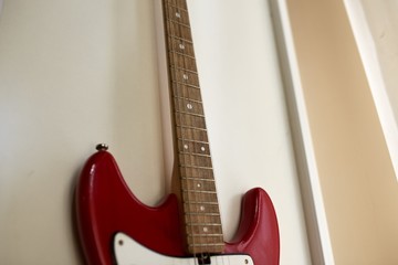  Old excellent electro and bass guitars on the shelf in the guitar shop