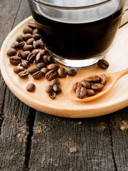 The black coffee and bean on spoon and cup.