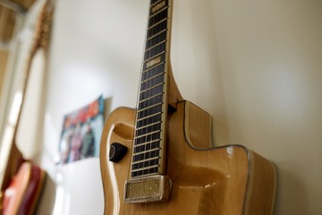  Old excellent electro and bass guitars on the shelf in the guitar shop
