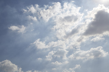 White curly clouds in a blue sky