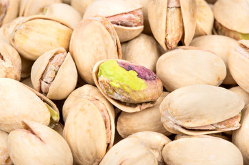 Background of salted pistachio nuts close up