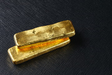 The gold bar put on the dark background represent gold and business finance concept related idea.