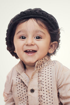 Portrait. happy little boy wearing cultural dress and hat