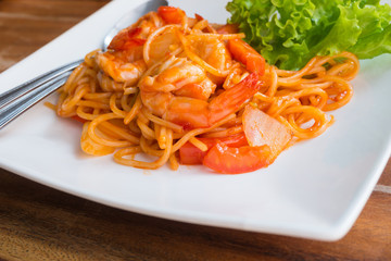 Close up stir fried spaghetti and prawn with tomato sauce