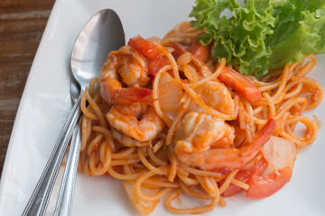 Close up stir fried spaghetti and prawn with tomato sauce