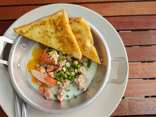 Breakfast thai food style:Close-up,pan-fried egg with pork and toppings