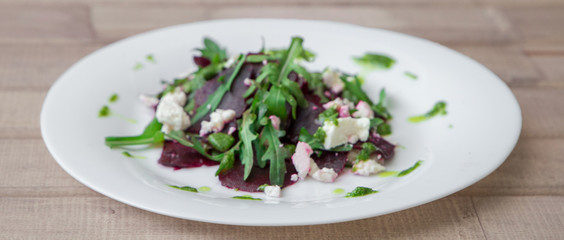 Salad with beet, feta, arugula and pesto