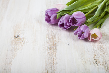 Bouquet of tulips on a wooden background.