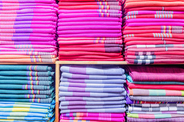 Colorful clothes in the cupboard.
