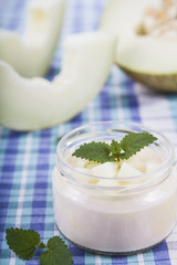 Obraz na płótnie Canvas Yogurt with melon. Delicious dairy dessert for breakfast.