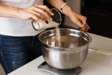 Weighing sugar powder on the digital scale.