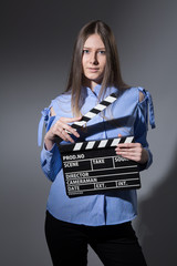 Young woman with a movie clapper