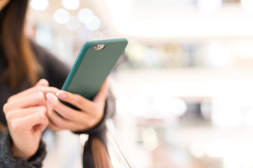 Woman sending sms on cellphone