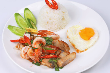 Jasmine rice topped stir - fried spicy basil with meat.