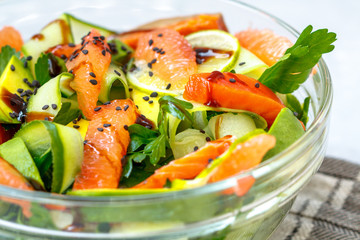 Citrus green salad with salmon, grapefruit and avocado.