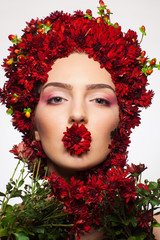 portrait of a girl covered in wild flowers on her head