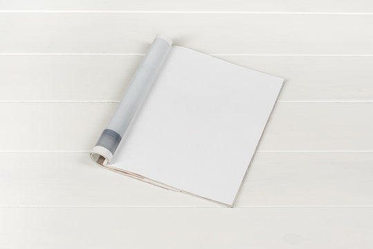 Mock-up magazine or catalog on white wooden table. Blank page or notepad on wood background. Blank page or notepad for mockups or simulations.