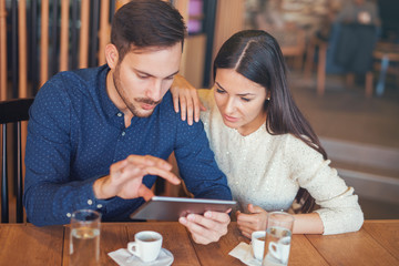 Young couple drinking coffee in a cafe. Dating, relationships, love, romance, lifestyle