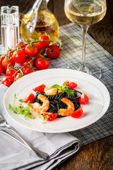 Black spaghetti with prawns and cherry tomatoes