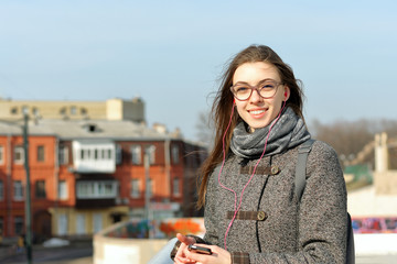 Beautiful girl listening to music on headphones