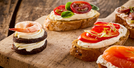 Assorted canapes on bread and blinis