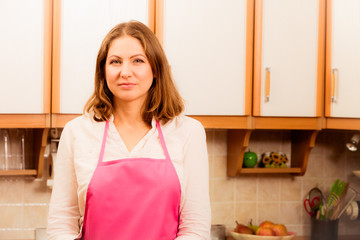 Happy housewife in kitchen