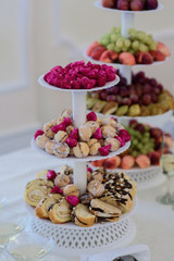 Tired plate with strawberries and pieces of cakes
