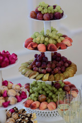 Delicious fruits served on tired dish
