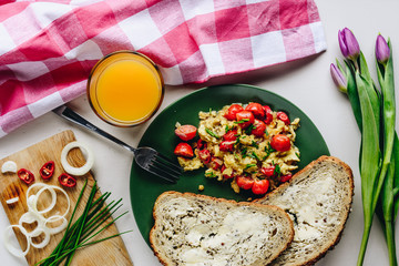 Scrambled eggs with cherry tomatoes and chili peppers