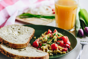 Scrambled eggs with cherry tomatoes and chili peppers