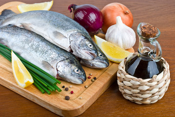 close-up raw fish trout on a wooden board