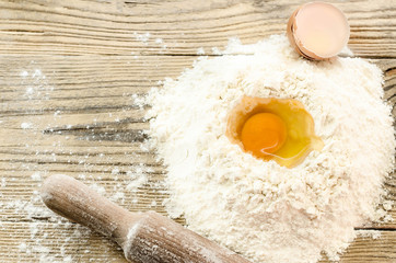 flour and egg for the .dough and roll on wooden background. Top view