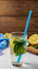 Homemade lemon lemonade with cucumber and mint on the rustic background