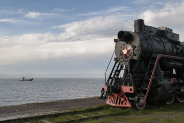 Retro locomotive on the waterlandscape background