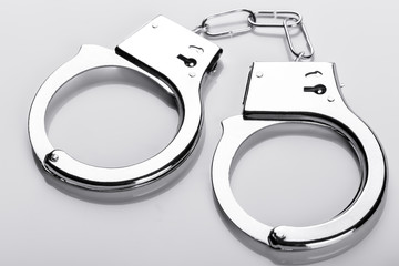 Pair of handcuffs on white