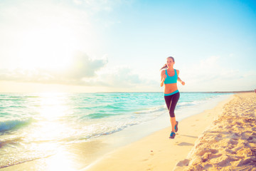 Fototapeta na wymiar Young Woman Jogging On The Beach