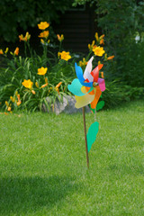 Children's pinwheel on the lawn in the garden © 7monarda