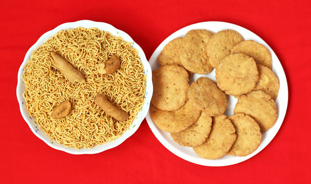Indian Mathari made with fine wheat flour and namkeen Bikaneri Bhujiya  made with chickpea flour (Besan), popular Indian snacks