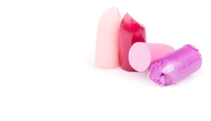 Broken and cut lipstick on white